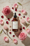 Rose Veil Elixir lifestyle flat lay with rose petals and rose quartz on marble